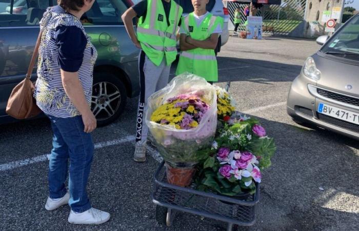 des adolescents portent des pots de fleurs au cimetière de Romans-sur-Isère